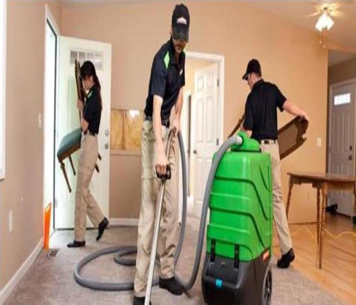 A SERVPRO team works to restore a home after water damage