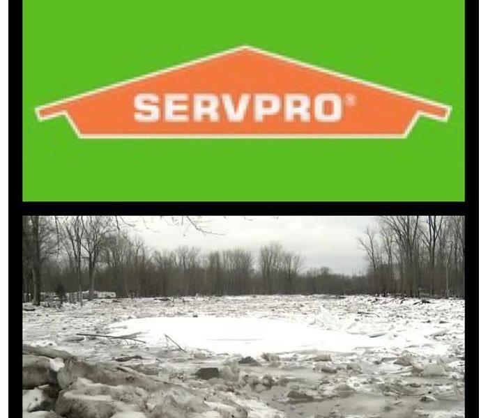 A photo showing ice in a creek backing up along with the SERVPRO house logo.